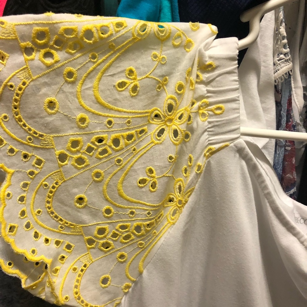 White top with yellow eyelet sleeves
